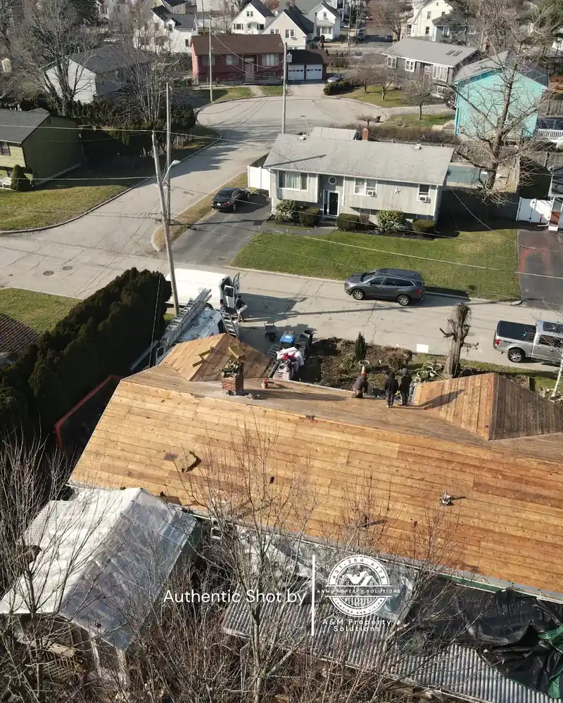 Storm damage restoration in progress with debris containment and crew on site.