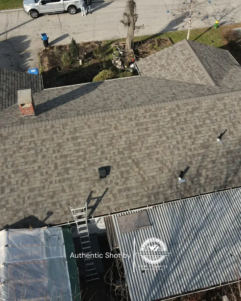 Roofing and siding exterior renovation nearing completion on a residential property.