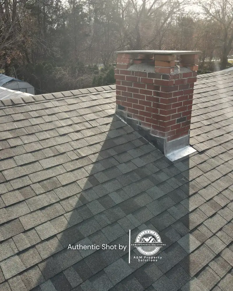 Finished roof with rebuilt chimney flashing detail on a Johnston, RI home.